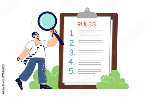Businessman is studying clipboard with rules for employees company, holding magnifying glass in hand