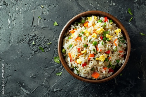 Traditional Chinese fried rice in a ceramic brown bowl on a rustic concrete table photo