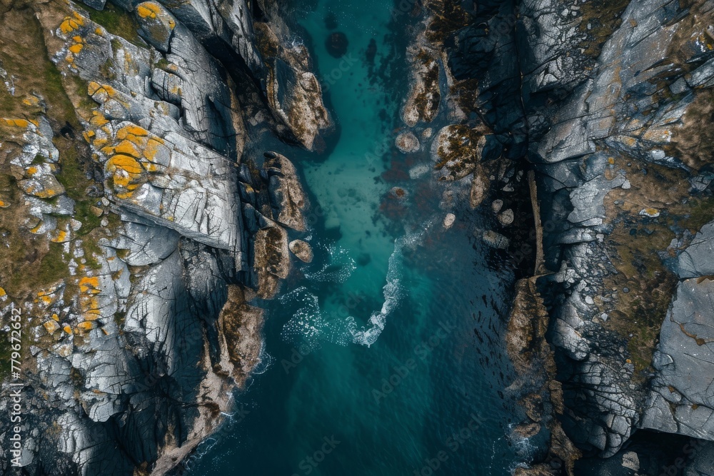 An aerial perspective capturing a body of water enclosed by rocks, showcasing the natural beauty of the landscape, A sky-high view of a narrow sea inlet surrounded by rocks, AI Generated An aerial perspective capturing a body of water enclosed by rocks, showcasing the natural beauty of the landscape, A sky-high view of a narrow sea inlet surrounded by rocks, AI Generated