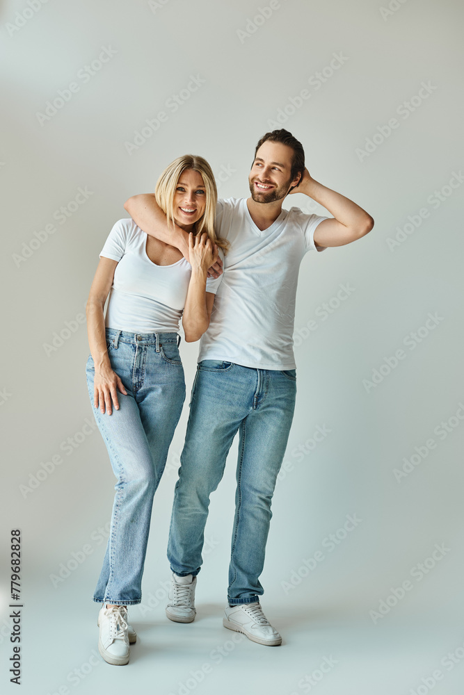 A stylish man and a beautiful woman strike a pose exuding charm and sophistication. A stylish man and a beautiful woman strike a pose exuding charm and sophistication.