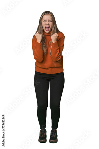 Studio portrait of a blonde Caucasian woman cheering carefree and excited. Victory concept.