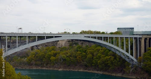 Bridge at US-Canada border in Niagara Falls. Border connects, units, and divides. Scenic border crossing, embodying peace, and cooperation. Cinematic shot of Neagar Bridge from Canada to the USA © ShantiMedia