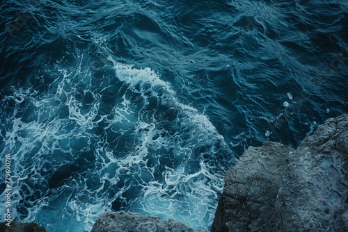 Dynamic aerial shot of dark blue ocean waves, capturing the raw power of nature, ideal for themes of adventure and the environment.

