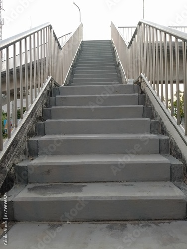 Heavenly Ascent: A stone staircase in the park, leading to success under the blue sky, blending old architecture with modern perspectives