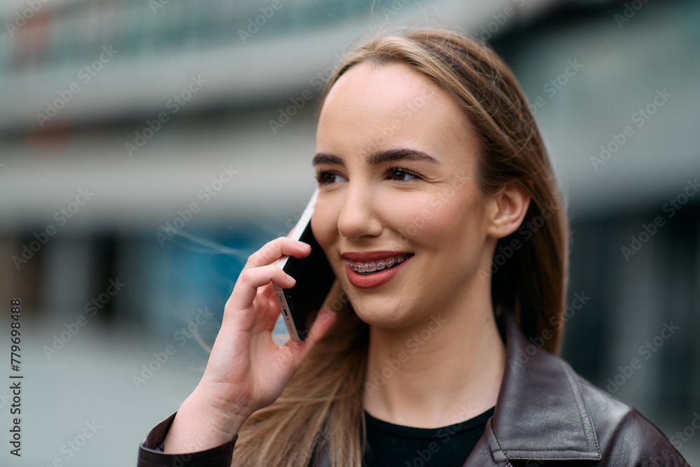 Business Woman With Phone Near Office. Portrait Of Beautiful Smiling Female In Fashion Office Clothes Talking On Phone While Standing Outdoors. Phone Communication. Business Woman With Phone Near Office. Portrait Of Beautiful Smiling Female In Fashion Office Clothes Talking On Phone While Standing Outdoors. Phone Communication.