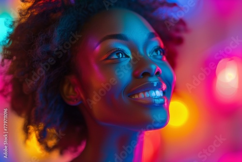 Portrait of a young beautiful smiling African American woman in neon light.