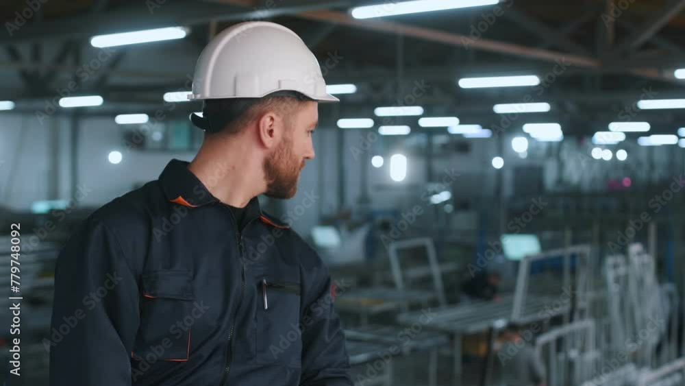 Handsome friendly guy. Factory worker is indoors with hard hat. Handsome friendly guy. Factory worker is indoors with hard hat.