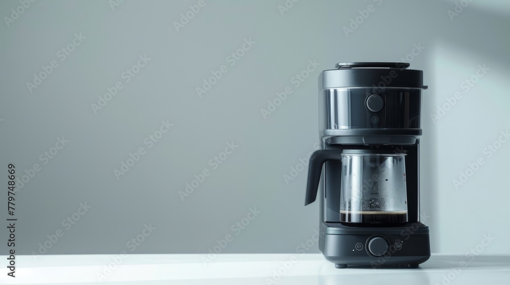 Modern black coffee maker with glass carafe on a kitchen countertop Modern black coffee maker with glass carafe on a kitchen countertop