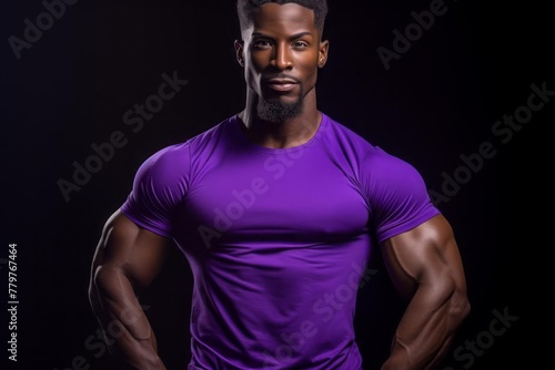 Afro American fitness model in purple t-shirt with well defined muscles