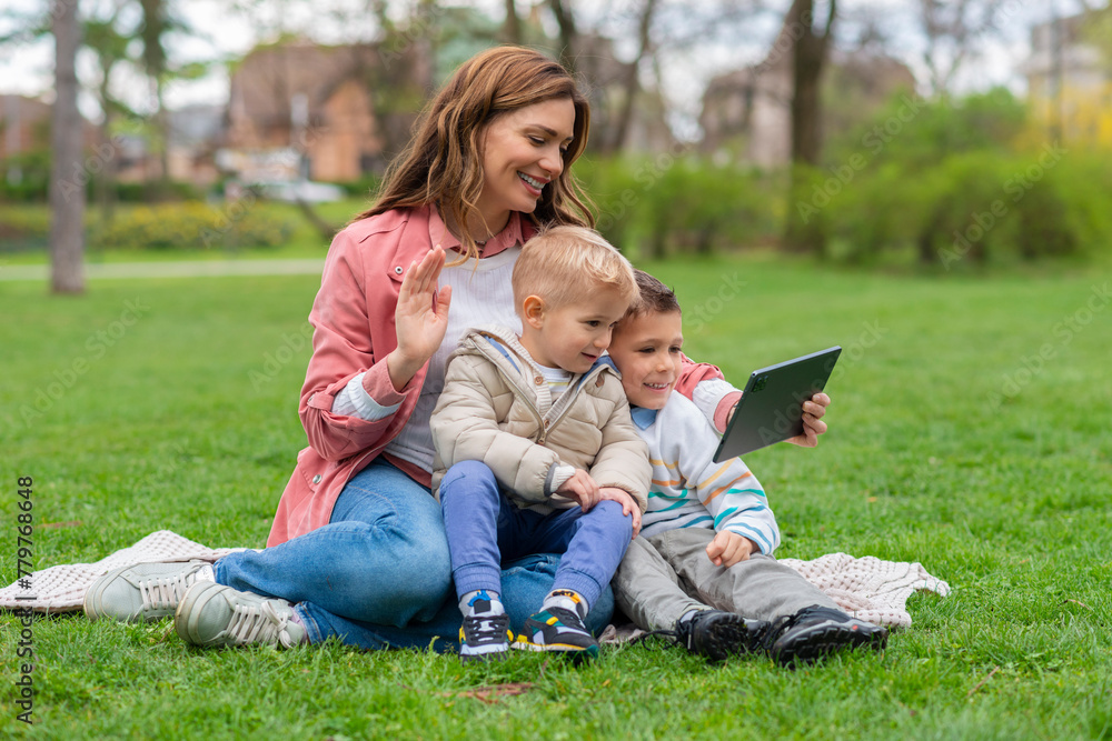 Mother and kids using tablet to talk online Mother and kids using tablet to talk online
