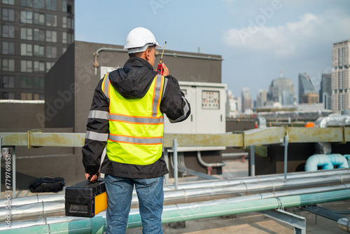 Engineer Inspecting Machinery at Industrial Site