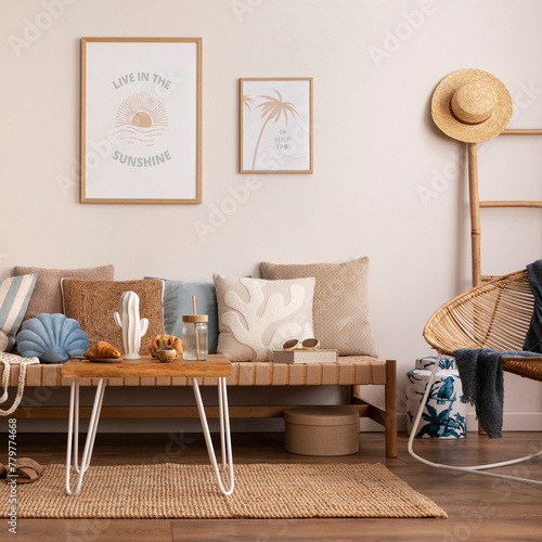 Sunny and bright space of living room with stylish sofa, pillows, coffee table, mock up poster frames, decorations, furnitures and personal accessories. Cozy home decor. Template. Summer vibe.