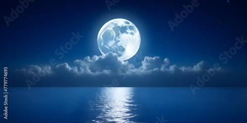 The full moon is shining brightly in the night sky, casting its reflection on the calm surface of the body of water below