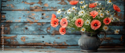 Clay jug with daisy and poppies on provencal wood plank background. photo