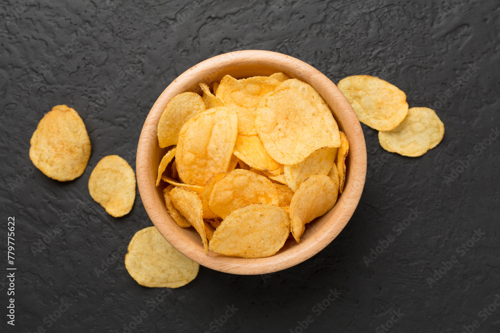 Appetizing potato chips on concrete background, top view