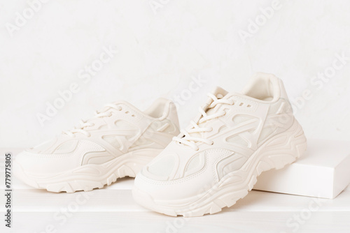 White woman trendy sneakers on concrete background