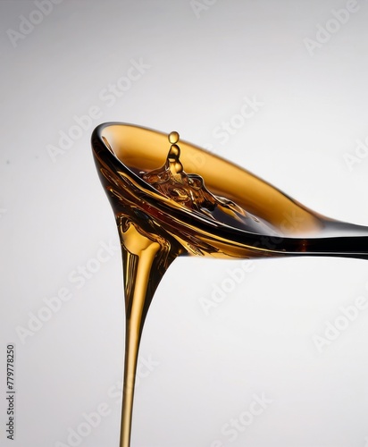 A smooth stream of honey flows from a spoon, showcasing its viscous beauty against a minimalist background AI generation