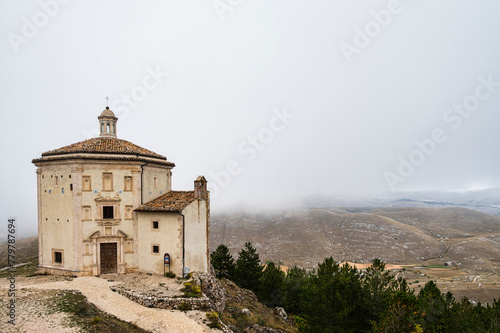 view of the church of Santa Maria della Pietà ( built in the xv century) close to the Castle of Rocca Calascio inside the Parco Nazionale del Gran Sasso e Monti della Laga, L'Aquila, Italy photo