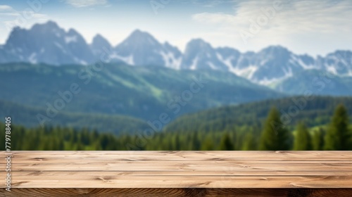 Empty brown wooden table with blurred background of high mountains.