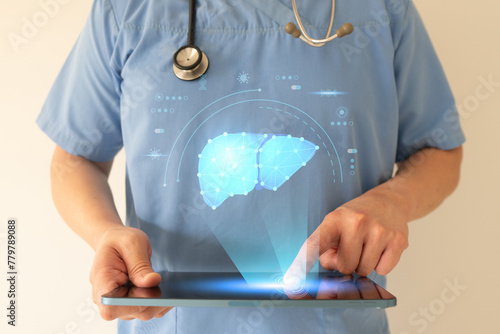 Foto Doctor check up liver organ hologram by digital tablet
