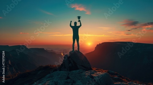 Silhouette of a businessman standing on top of a mountain holding a trophy for winners  success and leadership.