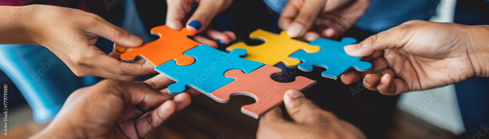 Hands from diverse team members holding puzzle pieces about to connect, illustrating the power of collaboration and unity in solving complex problems Hands from diverse team members holding puzzle pieces about to connect, illustrating the power of collaboration and unity in solving complex problems