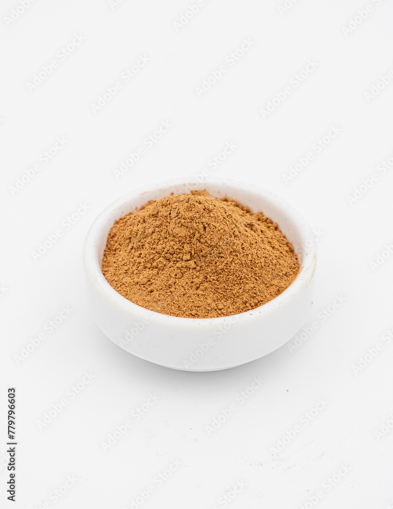 Seasoning. Ground cinnamon in white bowl on white background Seasoning. Ground cinnamon in white bowl on white background