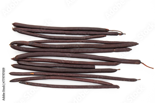 Thai herb - fruit of golden shower or cassia pods on white background cylindrical pod are solid, dark brown, almost black inside a thin membrane is found. and has small, flat, brown seeds.