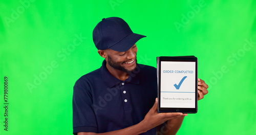 Tablet, delivery and complete with a black man on a green screen background in studio for distribution. Technology, supply chain logistics and order with a young male courier on chromakey mockup