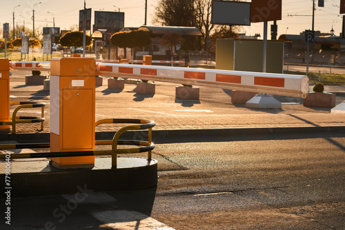 Automatic barrier gates for supermarket parking lot. Security system for car park entry to shopping mall. Vehicle entrance with boom barriers and control tickets machine