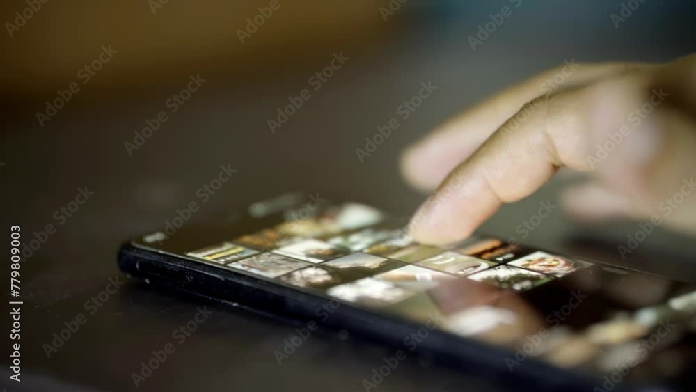 out-of-focus hand of a man using social networks through his cell phone, content not visible, man connecting through social networks out-of-focus hand of a man using social networks through his cell phone, content not visible, man connecting through social networks