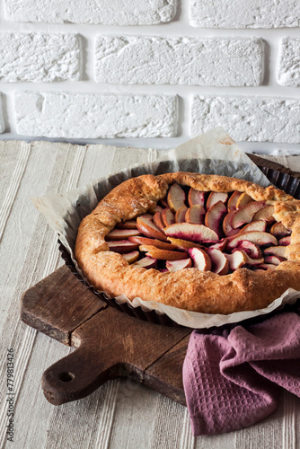 Slika na platnu Sweet galette with apples and elder berries on rustic wooden board