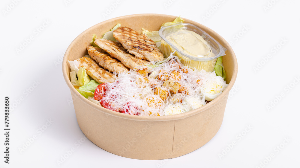 Caesar salad in paper bowl isolated on white Caesar salad in paper bowl isolated on white