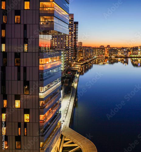 View of illuminated buildings by canal