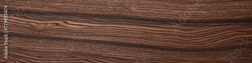Brown wooden surface exuding a natural warmth, its grainy texture adding a rustic charm to the inviting ambiance.