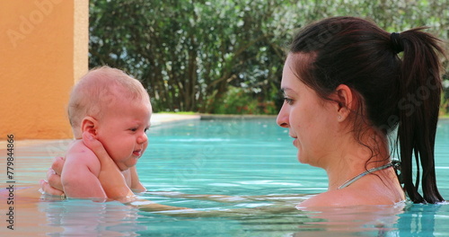 Mother and baby son at the swimming pool