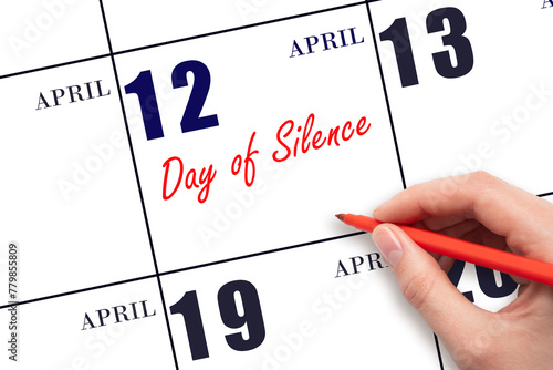 April 12. Hand writing text Day of Silence on calendar date. Save the date.