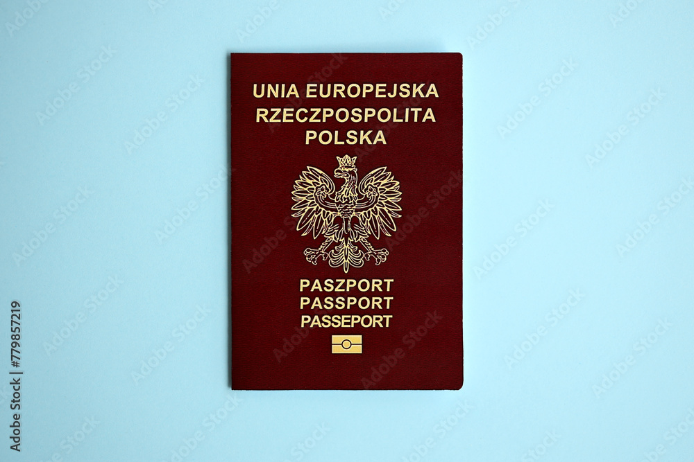 Poland passport on blue background close up. Tourism and citizenship concept Poland passport on blue background close up. Tourism and citizenship concept