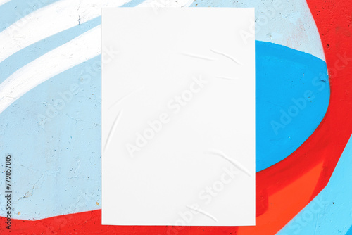 Closeup of colorful blue red white painted urban wall texture with wrinkled glued poster template. Modern mockup for design presentation. Creative urban city background. 