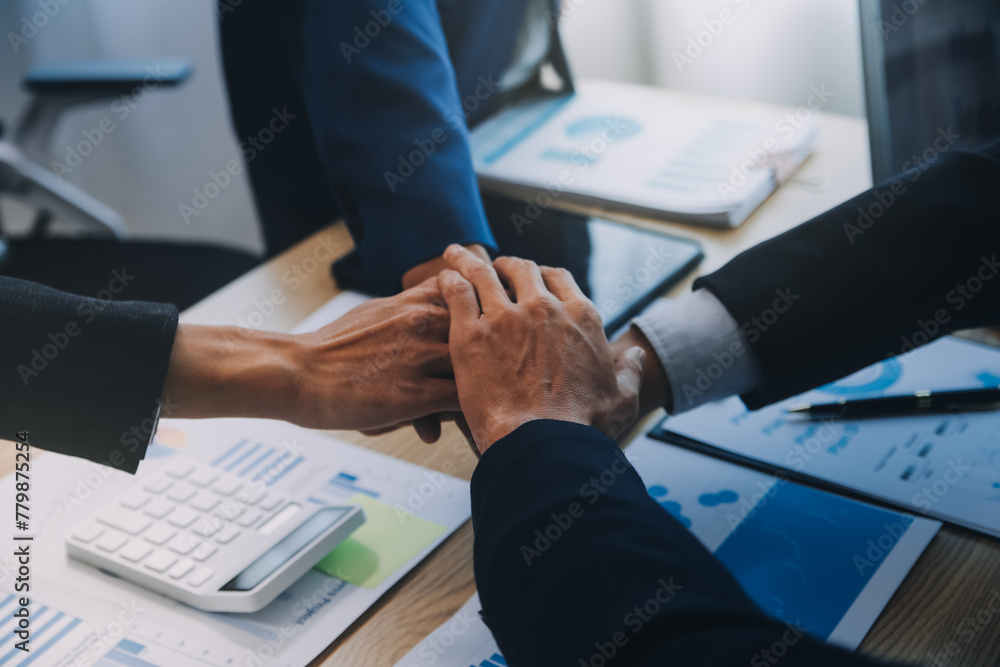 Business people join hands to join forces as a teamwork. Business people join hands to join forces as a teamwork.