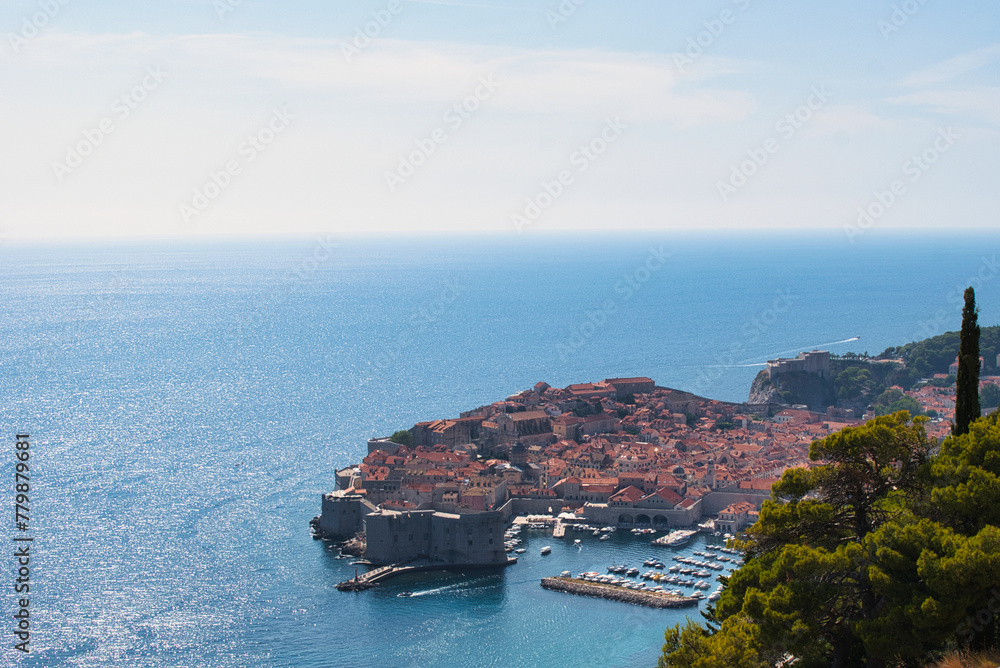 An amazing view of old town (medieval Ragusa) and Dalmatian Coast of Adriatic Sea in Dubrovnik. Blue sea with white yachts, beautiful landscape, aerial view, Dubrovnik, Croatia. 