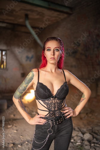 Portrait of a young beautiful girl with red hair in lingerie.