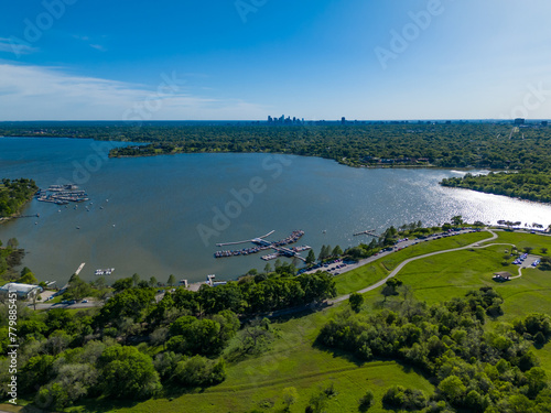 Dallas White Rock Lake Park and marina and Dallas skyline with blue sky and greenery