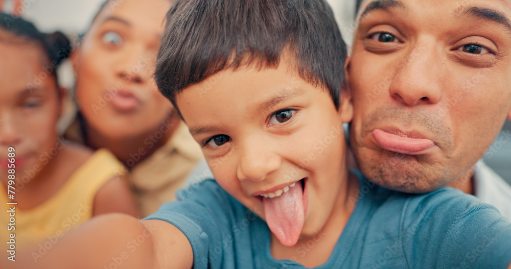 Family, selfie and funny face of children and parents together in a living room at home. face of a man, woman and young kids together for fun, happiness and picture while playing for bonding and care Family, selfie and funny face of children and parents together in a living room at home. face of a man, woman and young kids together for fun, happiness and picture while playing for bonding and care