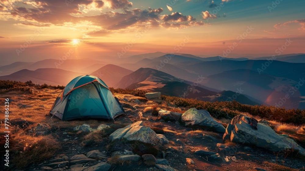 Camping tent at sunset in the mountains, with the soft hues of twilight casting a magical ambiance over the rugged landscape