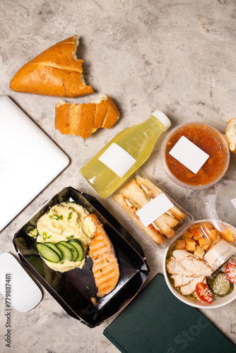 Top view of delicious lunch with laptop on table photo