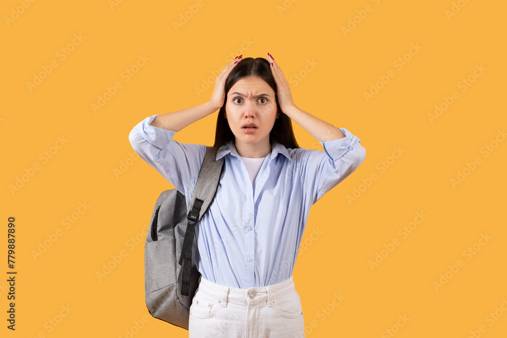 Worried young woman with hands on head Worried young woman with hands on head