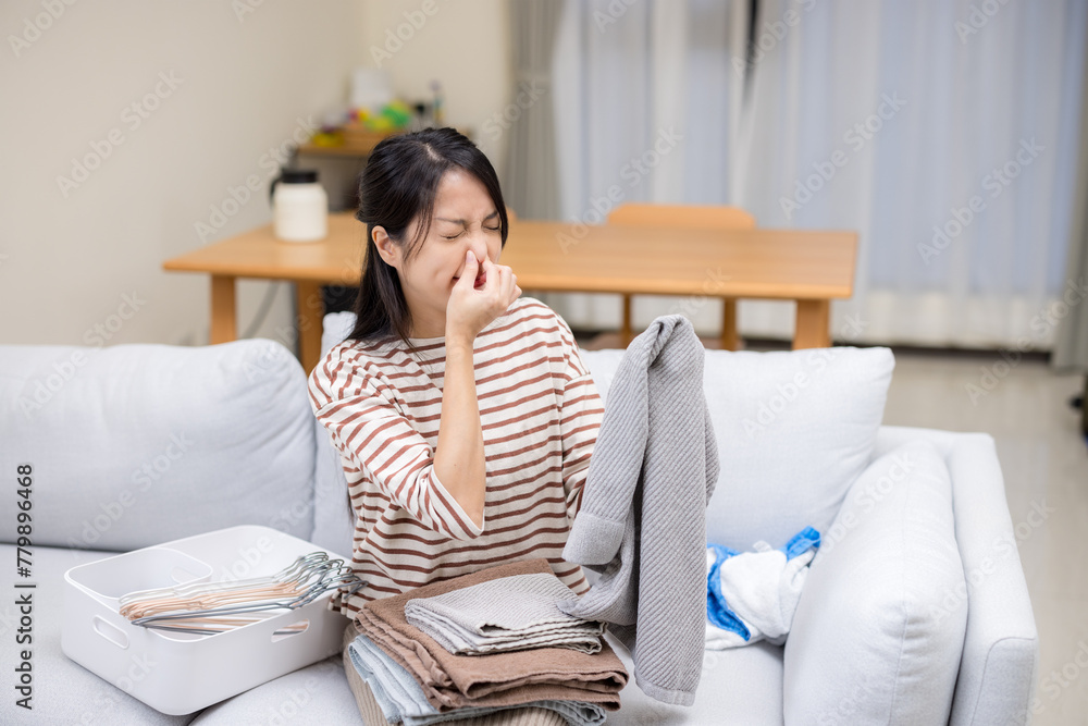 Woman have bad stinky smelly over the towel with her laundry housework at home Woman have bad stinky smelly over the towel with her laundry housework at home