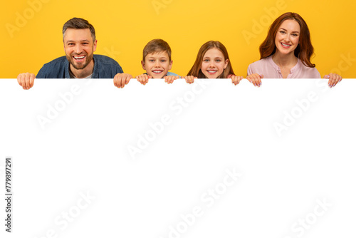 Family holding a white blank banner on yellow background