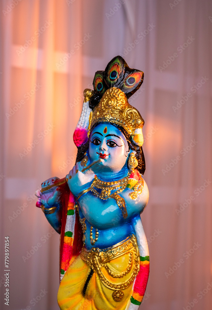 Hindu God Krishna sculpture isolated on white curtain Hindu God Krishna sculpture isolated on white curtain
